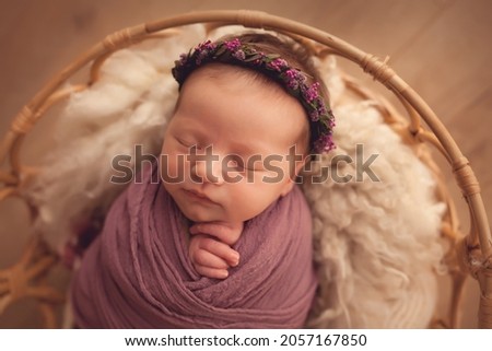 Adorable newborn baby girl is sleeping on beige background. Beginning of life and happy childhood concept Royalty-Free Stock Photo #2057167850