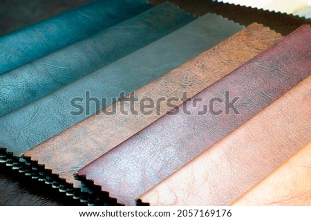 Catalog of multicolored leather in classic color shade .leatherette fabric texture. Industry background. Royalty-Free Stock Photo #2057169176