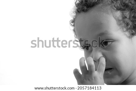 boy picking his nose on white background stock photo