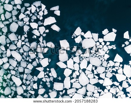 Ice floes on the water surface of the lake. Aerial top down view. Baikal lake, Siberia, Russia. Abstract nature background Royalty-Free Stock Photo #2057188283