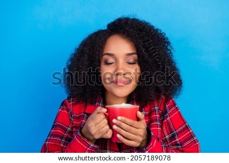 Photo of sweet rest millennial lady drink coffee wear red checkered pajama isolated on blue color background
