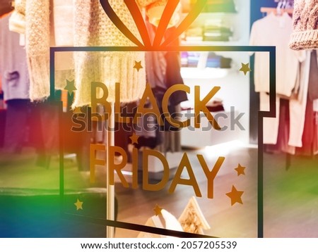 Showcase view with defocused products inside and Black Friday signage during the online and store shopping experience