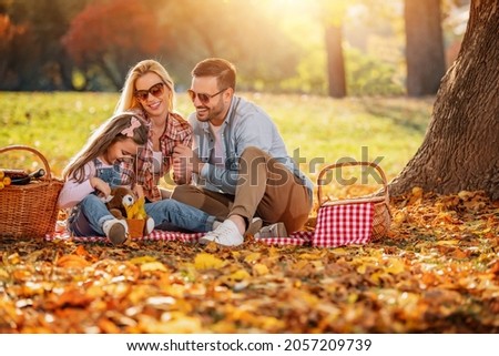 Joyful family picnicking in the park.Family picnicking together.Family on picnic at sunny day.Leisure, holidays, people and love concept.