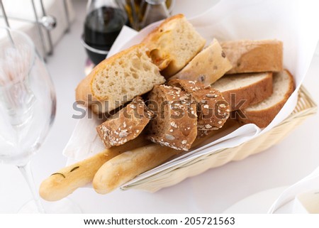 Various breads in basket on decorated table