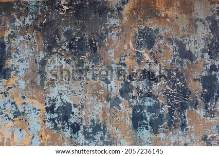 Rustic weathered concrete wall with layers of paint and plaster Royalty-Free Stock Photo #2057236145