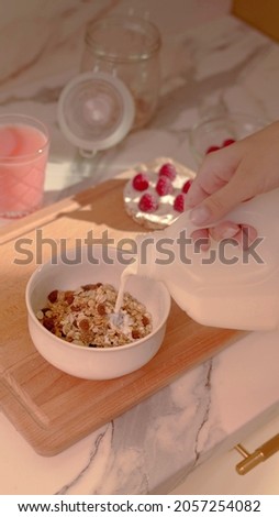 A woman is preparing a Bowl of cereal