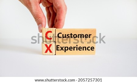 CX customer experience symbol. Concept words 'CX customer experience' on wooden blocks on white table, white background, copy space. Businessman hand. Business and CX customer experience concept. Royalty-Free Stock Photo #2057257301
