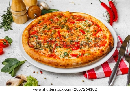 fast food, appetizing tasty pizza with ingredients on a light background