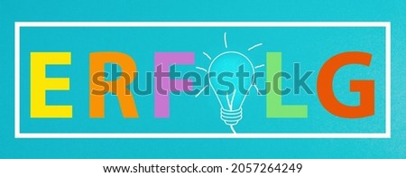 The word success is standing in german language on a blue colored background, light bulb between the letters