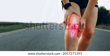 Sporty woman who suffered a knee accident during the run.  
 Joint  problems and tendon inflammation.   Royalty-Free Stock Photo #2057271395