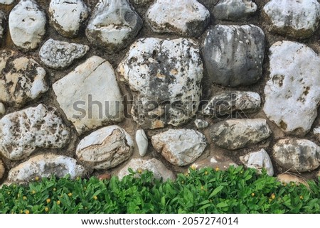Background with cobblestones and green grass below