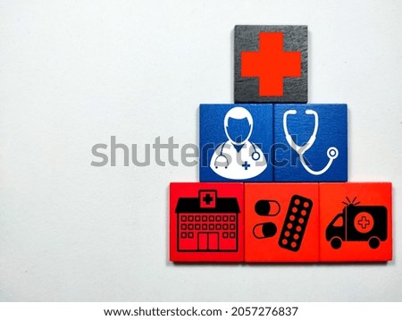 Selective focus.Colorful wooden cube with medical or hospital items on a white background.