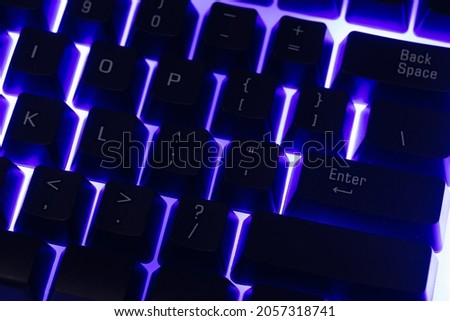 Colorful Accessory gaming keyboard with blank space background. Gadget for gamer playing video game online in the neon light darkroom.