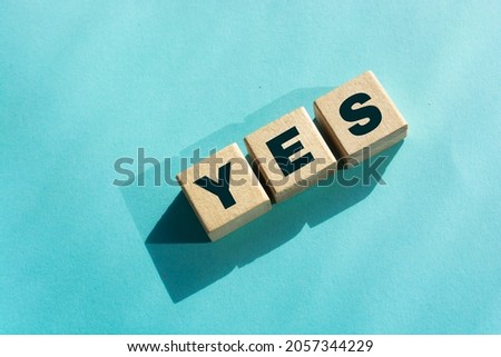 The word Yes! written in black letters on wooden cubes. Business, motivation and education concept