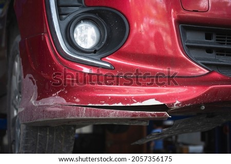 Close-up of damaged ,cracked and peeling paint on car front bumper. Royalty-Free Stock Photo #2057356175