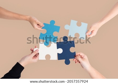 Hands holding puzzle business problem solving concept