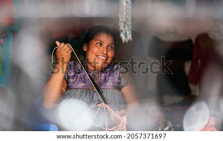 Mexican woman smiling and working in typical clothing store