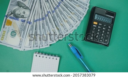 Many dollar money create pattern, make design shape picture. Top view, flat lay. Banknote dollar, calculator, pen, notepad on background.