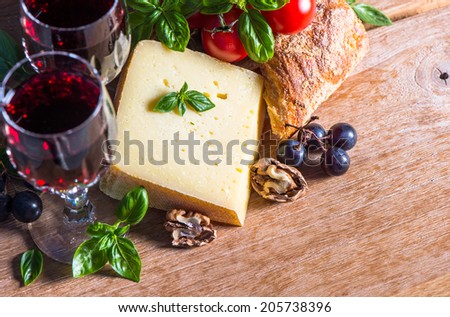 cheese with red wine and walnuts. food and beverages. selective focus. low key picture