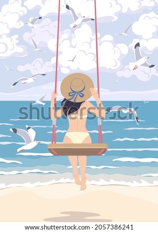 Young woman in straw hat swinging on swing at the sea coast. Girl in swimsuit back view. Vacation concept. Serenity landscape with blue water, waves and flying gulls. 