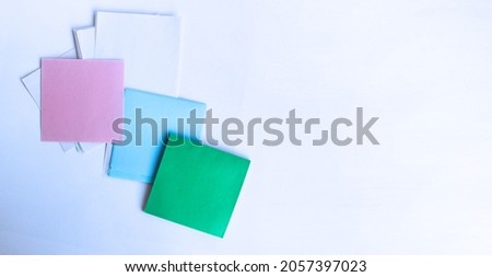 Pink, blue and green squares are paper for writing on a white background. Background for inscriptions.