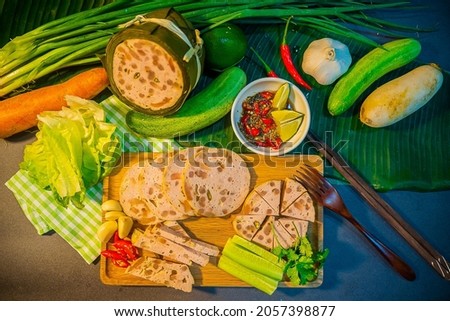 Traditional Vietnamese food, pork sausage or pork bologna with pepper, lemon and salt sauce on colorful background. Selective focus.