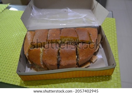 Sweet martabak with various very delicious flavors in a container with a green base.