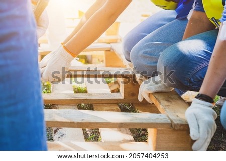 Working with wooden pallets. A man breaks a board in a pallet