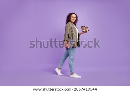 Full body photo of brunette hair trendy afro american woman walk hold coffee laptop isolated on purple color background