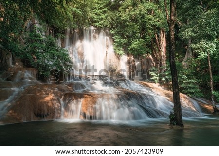 Beautiful Sai Yok Noi waterfall flowing on limestone in tropical rainforest at national park, Sai Yok, Kanchanaburi, Thailand