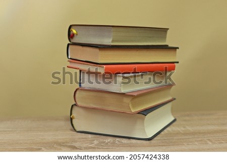 A pile of books on a yellow background