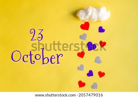 23 october day of month, colorful hearts rain from white cotton cloud on yellow background. Valentine's day, love and wedding concept