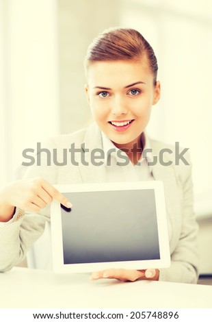 picture of smiling businesswoman with tablet pc in office