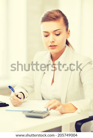 picture of businesswoman with notebook and calculator