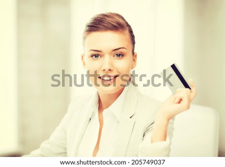 bright picture of smiling businesswoman showing credit card