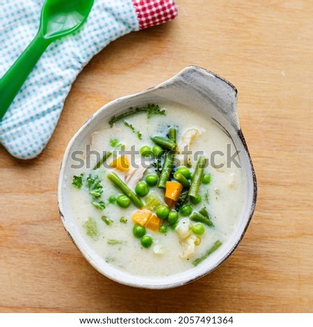 Kids healthy chicken soup with peas and carrots