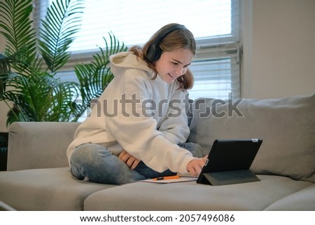 girl calls up with her friends on the video link hold arm show v-sign say hi friends relatives positive optimistic. cute lovely adorable girl making peace sign with her hands