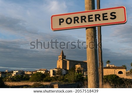 Close-up of the poster of the Mallorcan town of Porreres, with the town out of focus in the background. Island of Mallorca, Balearic Islands, Spain
