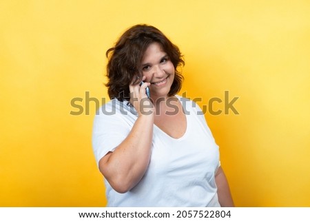 curvy young woman using technology with tablet and mobile phone