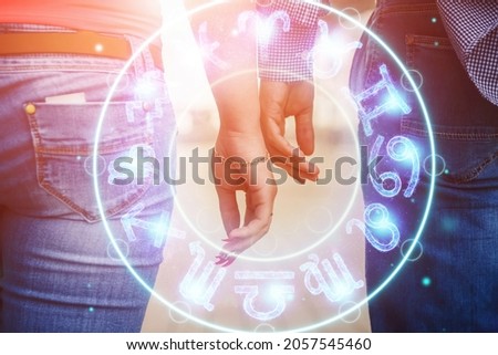 Horoscope concept, couple guy and girl on the background of a circle with the signs of the zodiac, astrology. Conceptual photo of a couple with perfect match between the signs of the zodiac Royalty-Free Stock Photo #2057545460