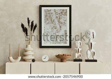 Stylish composition of modern beige living room interior design with designed sculptures, mock up poster frame, beige wooden sideboard and personal accessories. Template. Royalty-Free Stock Photo #2057546900