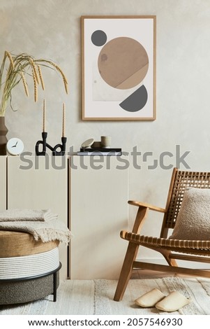Stylish and modern beige living room interior composition with mock up poster frame, beige wooden sideboard, armchair and boho inspired accessories. Copy space. Template.