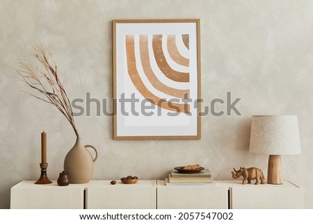 Creative composition of stylish living room interior with mock up poster frame, beige commode, clay vases and stylish personal accessories. Pastel neutral colours. Template. Royalty-Free Stock Photo #2057547002