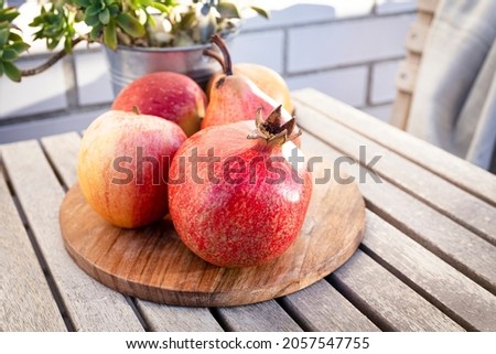 Seasonal fruit: pomegranates, apples and pears. Ripe fruit photography