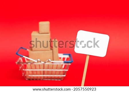 white tag close up on the background of a basket with boxes on a red background
