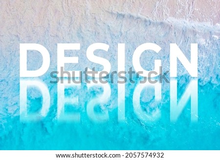 The word DESIGN written by the ocean with a wave on the beach. Background for advertising