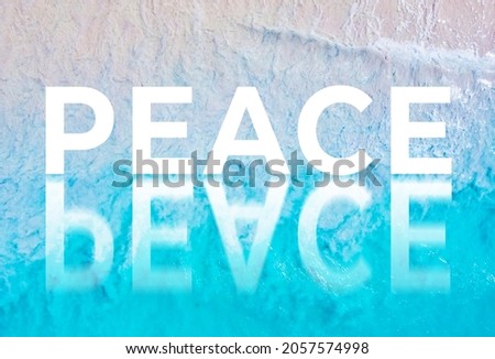The word PEACE written by the ocean with a wave on the beach. Background for advertising