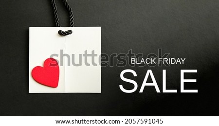 Black Friday or Valentine's Day Sale banner. Modern minimal design with red wooden heart on white paper tag. Template for promotion, advertising, web, social and fashion ads. High quality photo