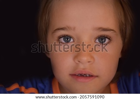 portrait of a child on a black background,