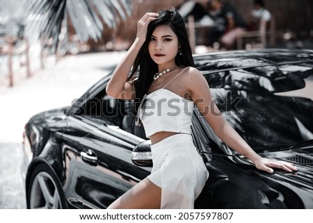 Beautiful asian girl in the in luxury car.
